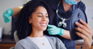 young woman smiling in a dental chair, perfect white teeth