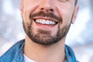 closeup of a bearded man with a perfect white smile