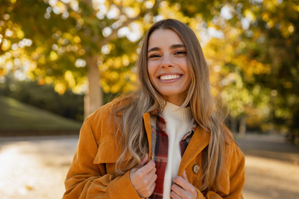smiling young woman outdoors, perfect white smile