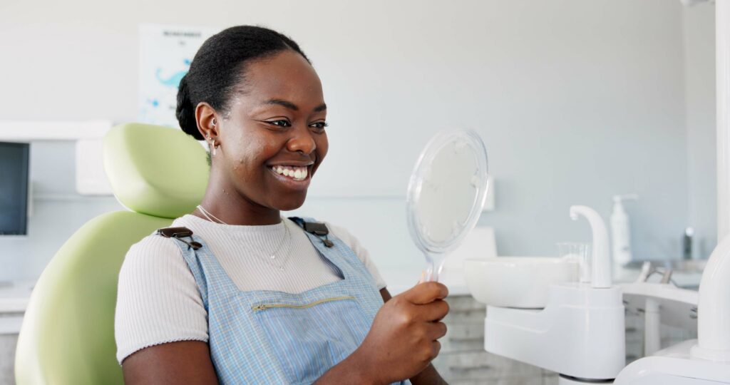 woman smiling in a dental chair, new white smile